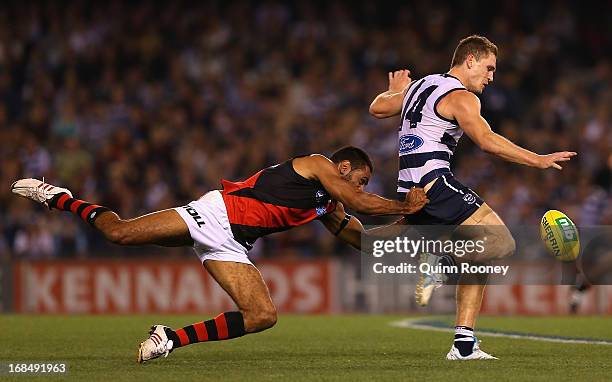 Nathan Lovett-Murray of the Bombers tackles Joel Selwood of the Cats during the round seven AFL match between the Geelong Cats and the Essendon...