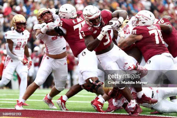 Trey Benson of the Florida State Seminoles scores a touchdown during the first half of the game between the Florida State Seminoles and the Boston...