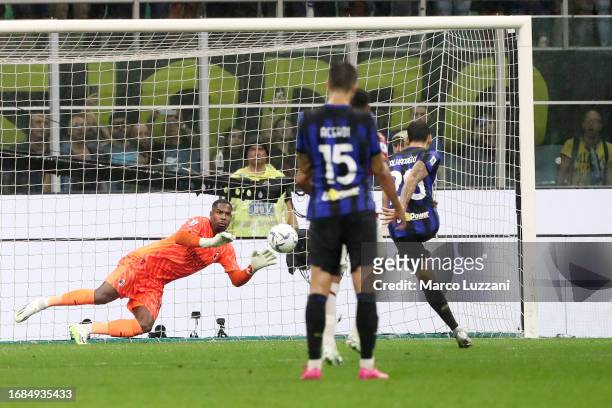 Hakan Calhanoglu of Inter Milan scores their sides fourth goal from the penalty spot during the Serie A TIM match between FC Internazionale and AC...