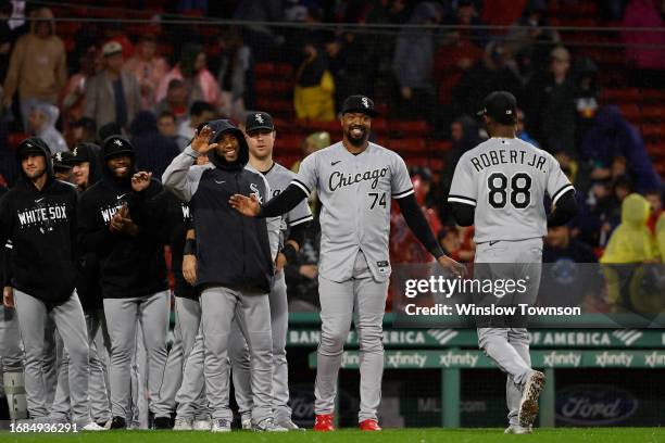 Eloy Jimenez of the Chicago White Sox and teammates wait to greet Luis Robert Jr. #88 after their 1-0 win over the Boston Red Sox on Robert Jr.'s...