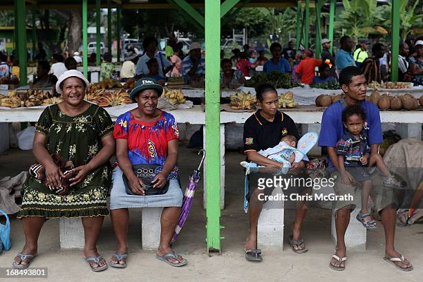 Market sellers wait to see Australian Prime Minister Julia Gillard during her tour of the Gerehu Market on May 10, 2013 in Port Moresby, Papua New...