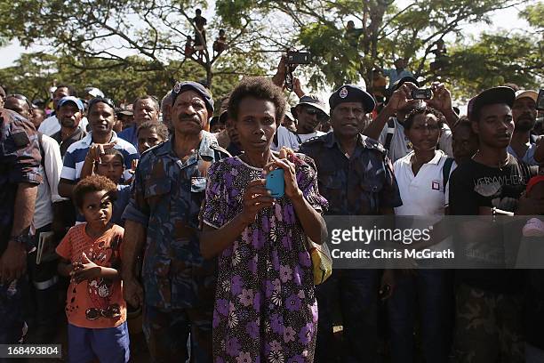 Members of the public wait to see Australian Prime Minister Julia Gillard during her tour of the Gerehu Market on May 10, 2013 in Port Moresby, Papua...