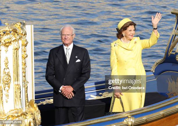 King Carl XVI Gustaf and Queen Silvia of Sweden arrive in the Royal Barge Vasaorden outside of the Royal Palace after a horse-drawn cortège through...