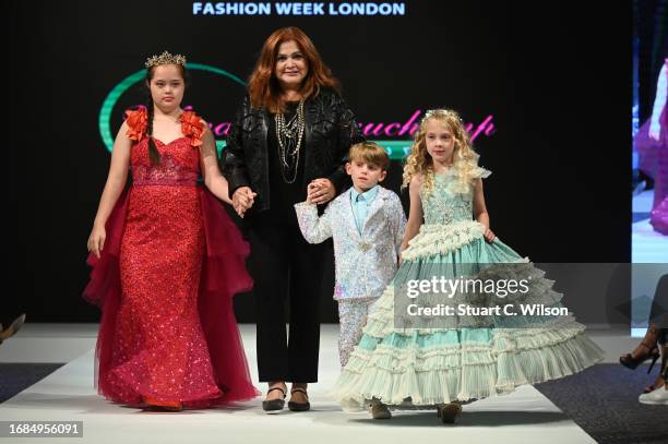 Designer Wanda Beauchamp and models walk the runway in the finale for Wanda Beauchamp at the House of Ikons show during London Fashion Week September...