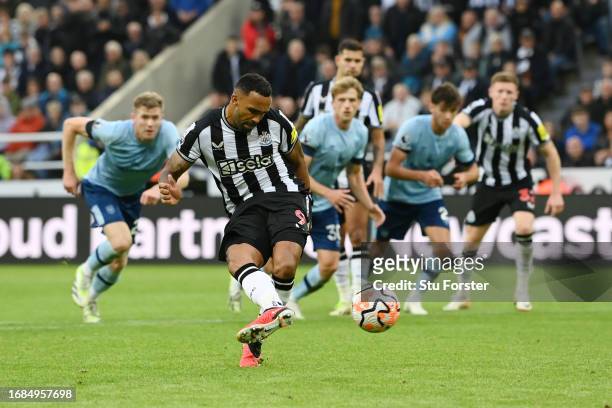 Callum Wilson of Newcastle United scores their sides first goal from the penalty spot during the Premier League match between Newcastle United and...