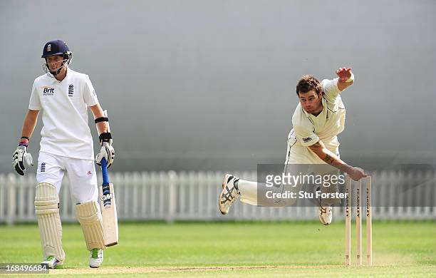 England batsman Joe Root looks on as New Zealand bowler Doug Bracewell delivers during day two of the tour match between England Lions and New...