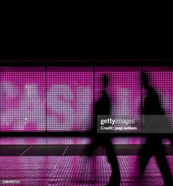 walking in led light - billboard night stock pictures, royalty-free photos & images