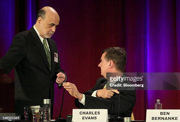 Ben S. Bernanke, chairman of the U.S. Federal Reserve, left, speaks with Charles Evans, president and chief executive officer of the Federal Reserve...