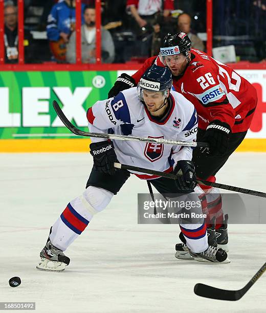 Michal Sersen of Slovakia and Thomas Vanek of Austria battle for the puck during the IIHF World Championship group H match between Slovakia and...