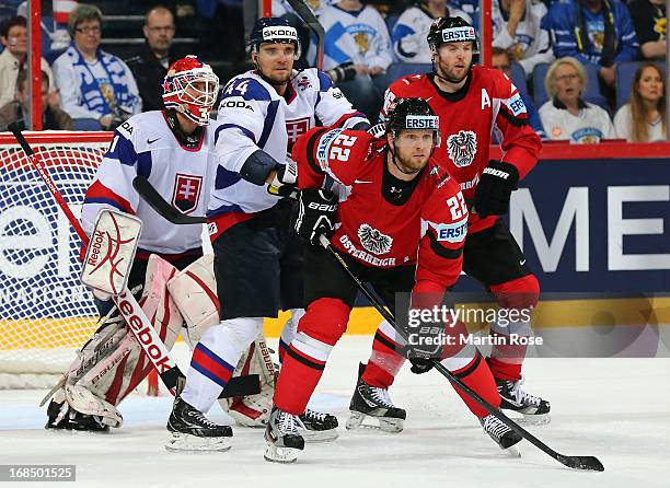 Andrej Sekera of Slovakia and Thomas Pock of Austria battle for position during the IIHF World Championship group H match between Slovakia and...