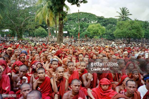 Buddhist monks listen to unseen opposition leader Aung San Suu Kyi, August 27, 1988 during a rally held in Yangon. As China celebrates the start of...
