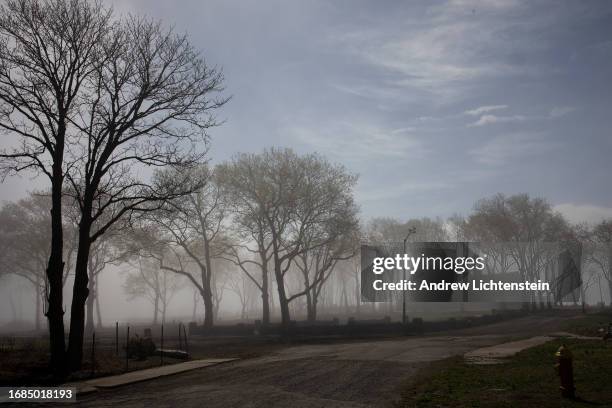 Landscape views of Hart Island, New York Citys burial grounds for the poor, unknown, and unclaimed. April 16 as seen from City Island in the Bronx,...