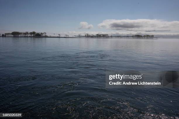 Landscape views across Long Island Sound at Hart Island, New York Citys burial grounds for the poor, unknown, and unclaimed. April 16 as seen from...