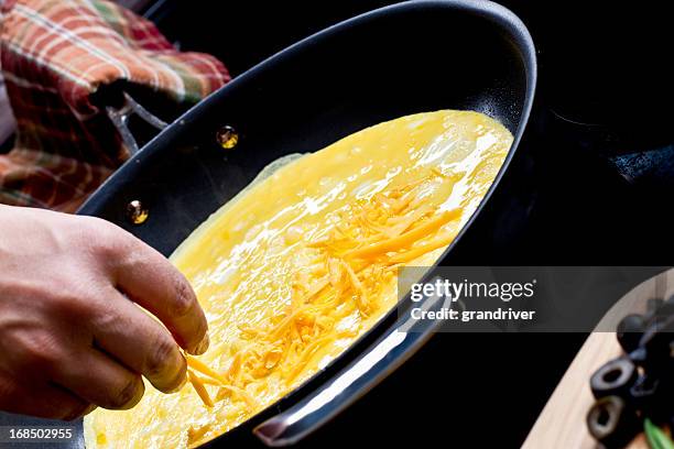 making cheese omelette - omelette stock pictures, royalty-free photos & images