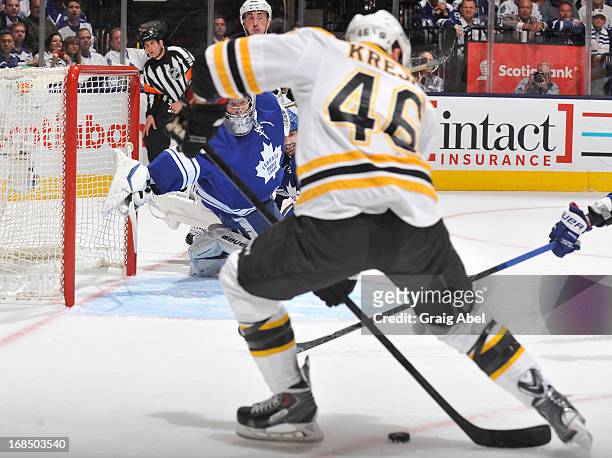 James Reimer of the Toronto Maple Leafs dives across the crease as David Krejci of the Boston Bruins looks to shoot the puck in Game Four of the...