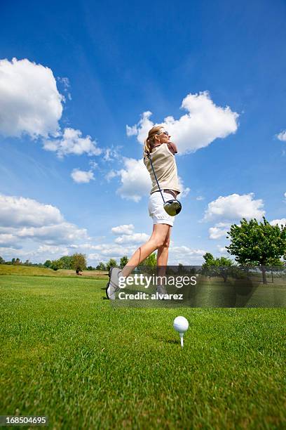 woman golfer taking a good golf swing - golf bunker low angle stock pictures, royalty-free photos & images