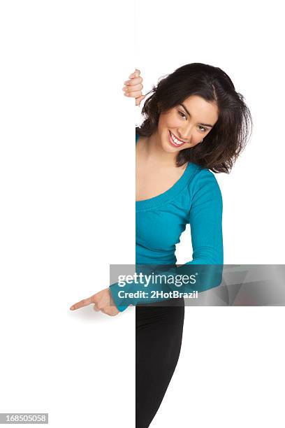 young woman pointing around a blank wall - isolated - 2hotbrazil bildbanksfoton och bilder