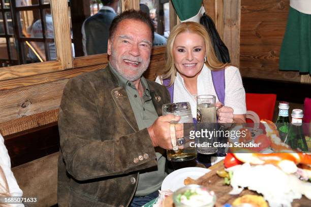 Arnold Schwarzenegger and Heather Milligan during the 188th Oktoberfest at Marstall tent on September 23, 2023 in Munich, Germany.