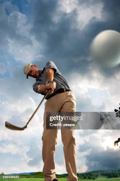 golfer hitting ball - man swinging golf club stock pictures, royalty-free photos & images