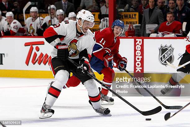 Milan Michalek of the Ottawa Senators skates with the puck against Brendan Gallagher of the Montreal Canadiens in Game Five of the Eastern Conference...