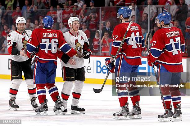 Sergei Gonchar and Chris Neil of the Ottawa Senators exchange a hand shake with P.K. Subban, Jarred Tinordi and Rene Bourque of the Montreal...
