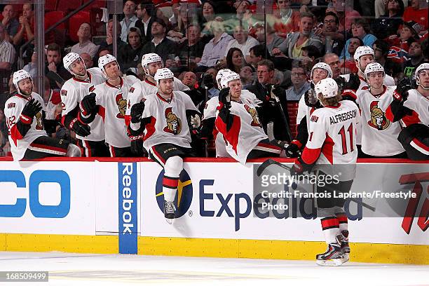 Daniel Alfredsson of the Ottawa Senators celebrates his goal at the bench with teammates against the Montreal Canadiens in Game Five of the Eastern...