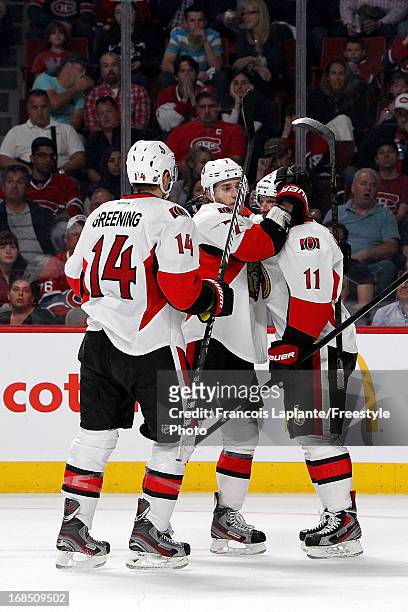 Kyle Turris of the Ottawa Senators celebrates a goal with teammates Daniel Alfredsson and Colin Greening against the Montreal Canadiens in Game Five...