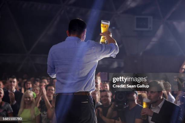 Slawomir Mentzen, co-leader of the Konfederacja alliance of right-wing and far-right political parties, toasts supporters with a glass of beer while...