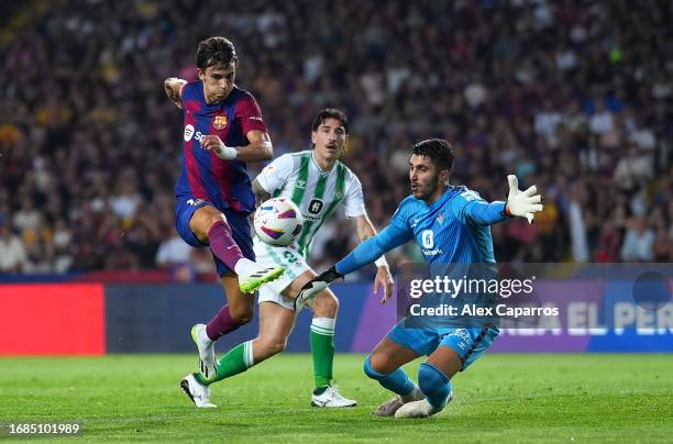 Joao Felix of FC Barcelona scores the team's first goal during the LaLiga EA Sports match between FC Barcelona and Real Betis at Estadi Olimpic Lluis...