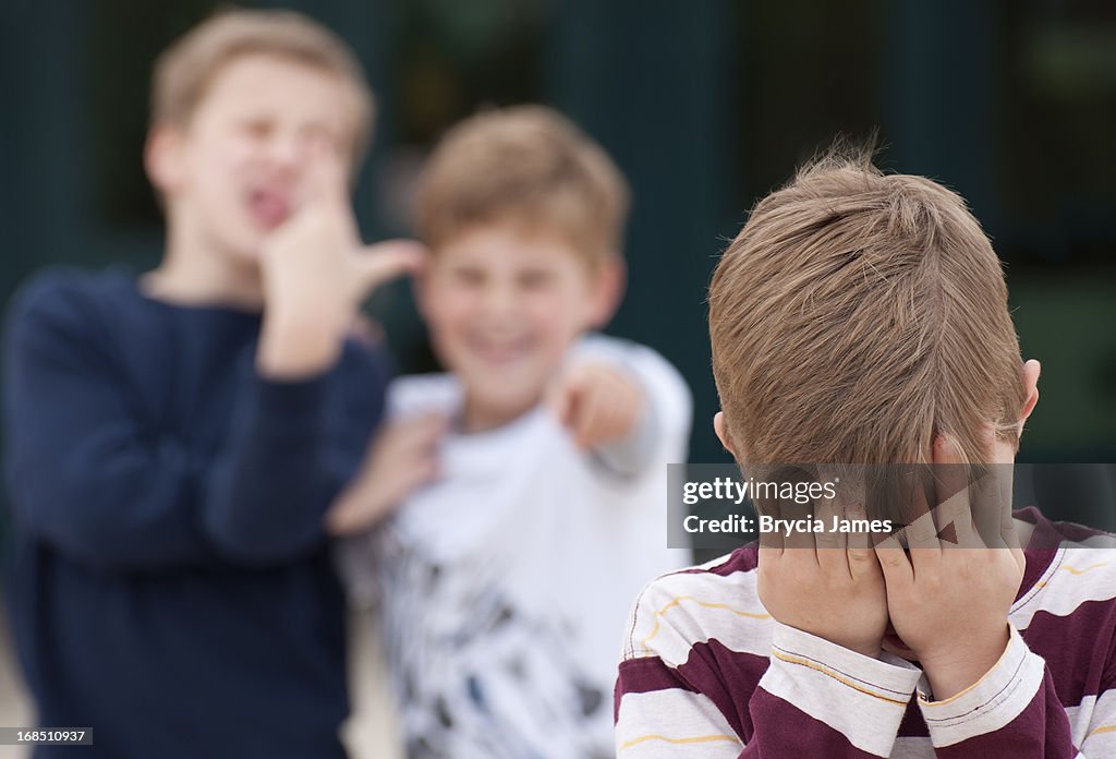 Elementary Student Hides His Face While Being Bullied