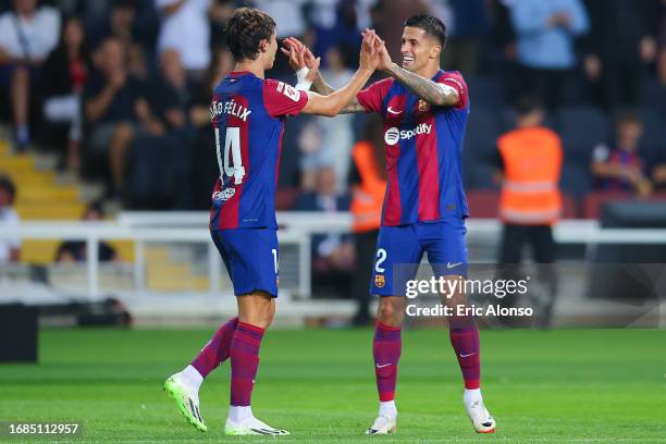 Joao Felix of FC Barcelona celebrates with Joao Cancelo of FC Barcelona after scoring the team's first goal during the LaLiga EA Sports match between...