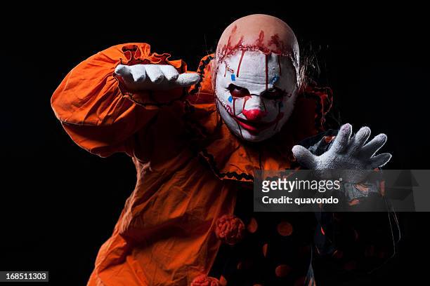 creepy halloween clown in bloody mask, portrait on black - halloween 2011 stock pictures, royalty-free photos & images