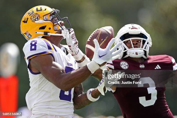 Malik Nabers of the LSU Tigers catches a pass against Decamerion Richardson of the Mississippi State Bulldogs during the second half at Davis Wade...