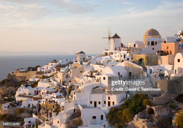 the village at sunset, oia, santorini, greece - oia santorini stock pictures, royalty-free photos & images