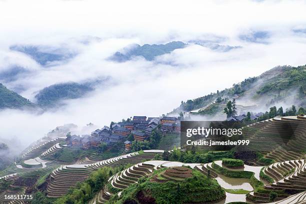 clouds around yao tribe village - yao tribe stock pictures, royalty-free photos & images