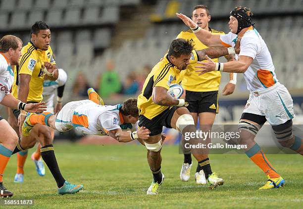 Andre Taylor and the defending player on the right are Phillip van der Walt, and Piet van Zyl with the flying tackle during the Super Rugby match...