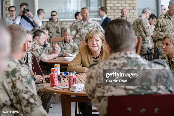 In this photo provided by the German Government Press Office , German Chancellor Angela Merkel talks to soldiers in a mess hall on May 10, 2013 in...