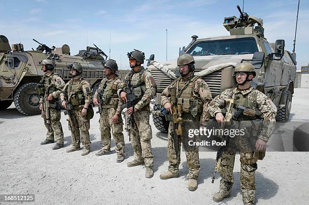 In this photo provided by the German Government Press Office , soldiers look on as German Chancellor Angela Merkel visits on May 10, 2013 in Kunduz,...