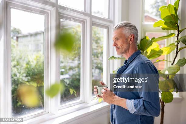 homme à la maison buvant une tasse de café - europe du nord photos et images de collection