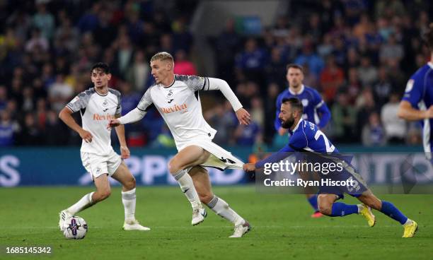 Jay Fulton of Swansea City on the ball whilst under pressure from Manolis Siopis of Cardiff City during the Sky Bet Championship match between...