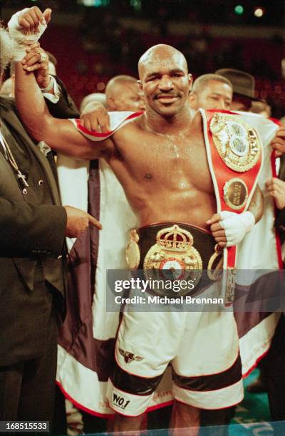 American boxer Evander Holyfield carries his belt after winning the fight against Michael Moorer in Las Vegas, 8th November 1997. Evander Holyfield...