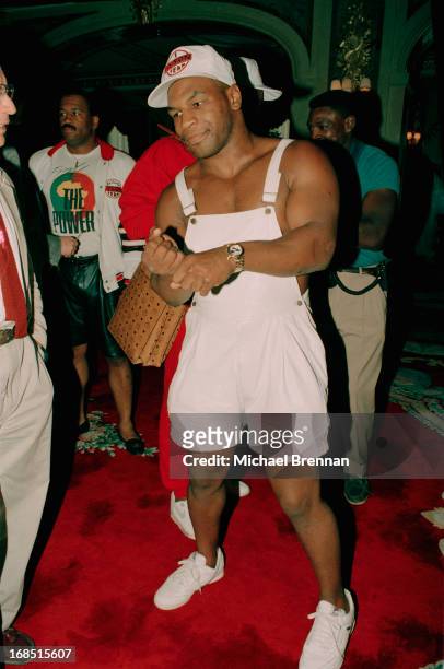 American boxer Mike Tyson arrives for a press conference wearing white leather dungaree shorts, New York City, 1984.