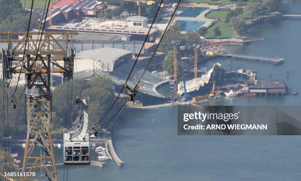 Tourist are seen in the cabin of the Pfanderbahn cable car network, manufactured by Austrian ropeway company Doppelmayr, on their way down from Mount...