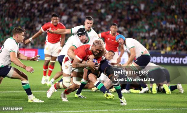 Vaea Fifita of Tonga is tackled by Caelan Doris of Ireland as he scores his team's first try during the Rugby World Cup France 2023 match between...