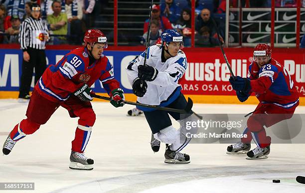 Kirill Petrov of Russia and Jarno Koskiranta of Finland battle for the puck during the IIHF World Championship group H match between Russia and...