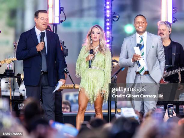 Carson Daly, singer-songwriter Carrie Underwood and Craig Melvin are seen on stage during NBC's "Today" show Citi Concert Series at Rockefeller Plaza...