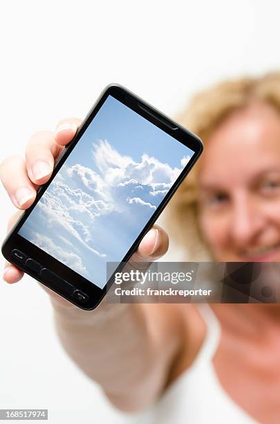 hand holding smartphones with clouds on screen - lens flare white background stock pictures, royalty-free photos & images