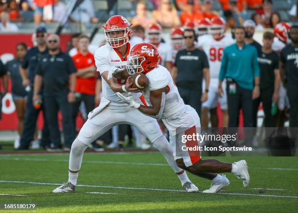 Sam Houston State Bearkats quarterback Grant Gunnell hands the ball to Sam Houston State Bearkats running back Zach Hrbacek in the first quarter...