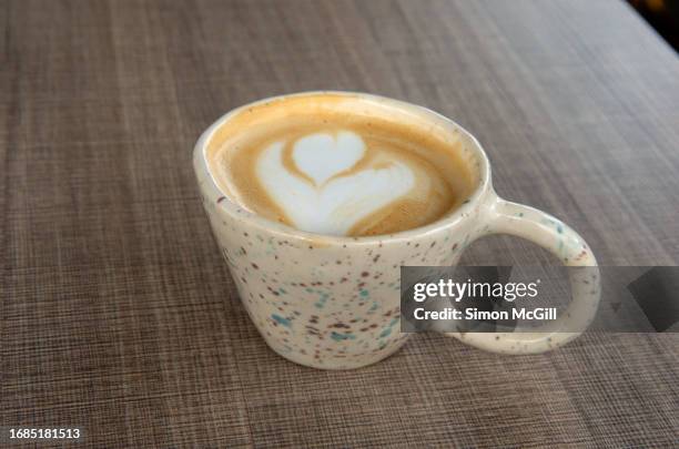 cappuccino coffee in a handmade ceramic coffee cup on a cafe table - homemade stock pictures, royalty-free photos & images