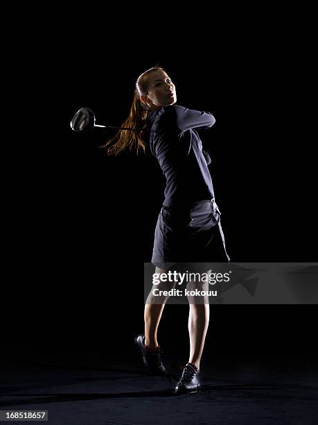 silhouette of woman playing golf - golf swing female stock pictures, royalty-free photos & images